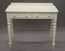 A Victorian white painted two drawer side table and a white painted marble topped wash stand.