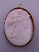 A cameo brooch carved with a young lady. 4.5 cm high.