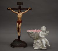 A porcelain model of the crucifixion and a porcelain cherub riding a dolphin. The former 38 cm high.