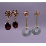 Two pairs of Chinese gold earrings, one set with jade, the other set with garnet.