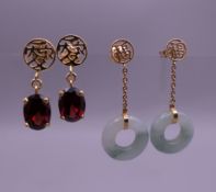 Two pairs of Chinese gold earrings, one set with jade, the other set with garnet.