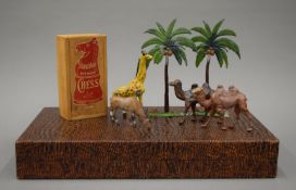 A chess set and board, and a small quantity of lead animals.