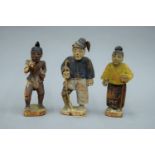 Three Eastern carved wooden figures. The largest 16.5 cm high.