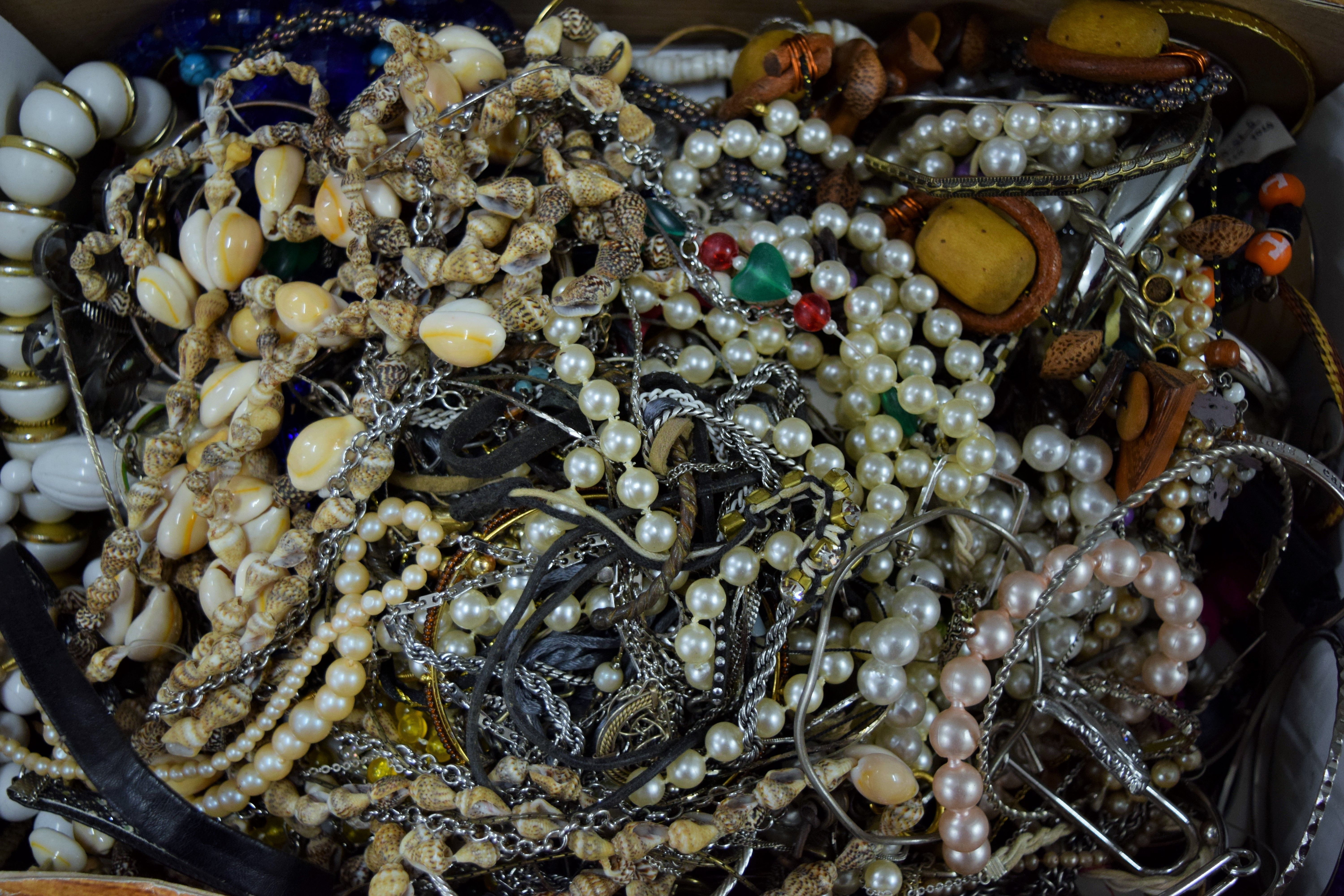 Three boxes of costume jewellery.