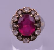 A 9 ct gold red stone ring. Ring size H.
