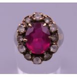 A 9 ct gold red stone ring. Ring size H.