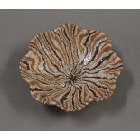 A small Chinese brown pottery dish. 10.5 cm diameter.