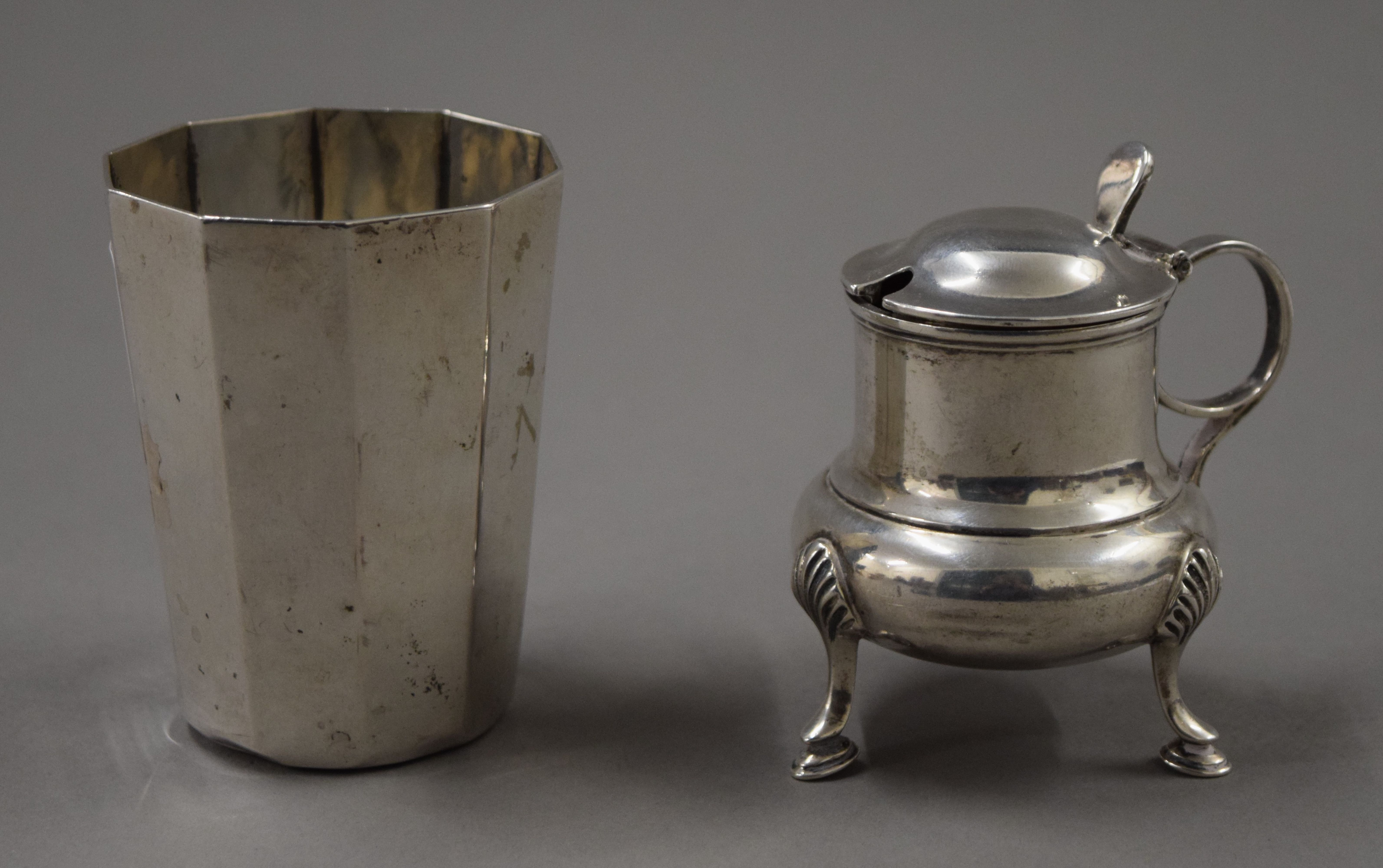 A silver mustard pot and an 835 silver beaker. The latter 8 cm high. 173.2 grammes.