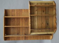 Two pine hanging shelves. The largest 110.5 cm wide, the other 55.5 cm wide.