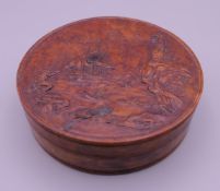 A 19th century carved burr wood and tortoiseshell snuff box. 8 cm diameter.