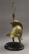 A French brass fireman's helmet formed as a lamp. 68 cm high overall.