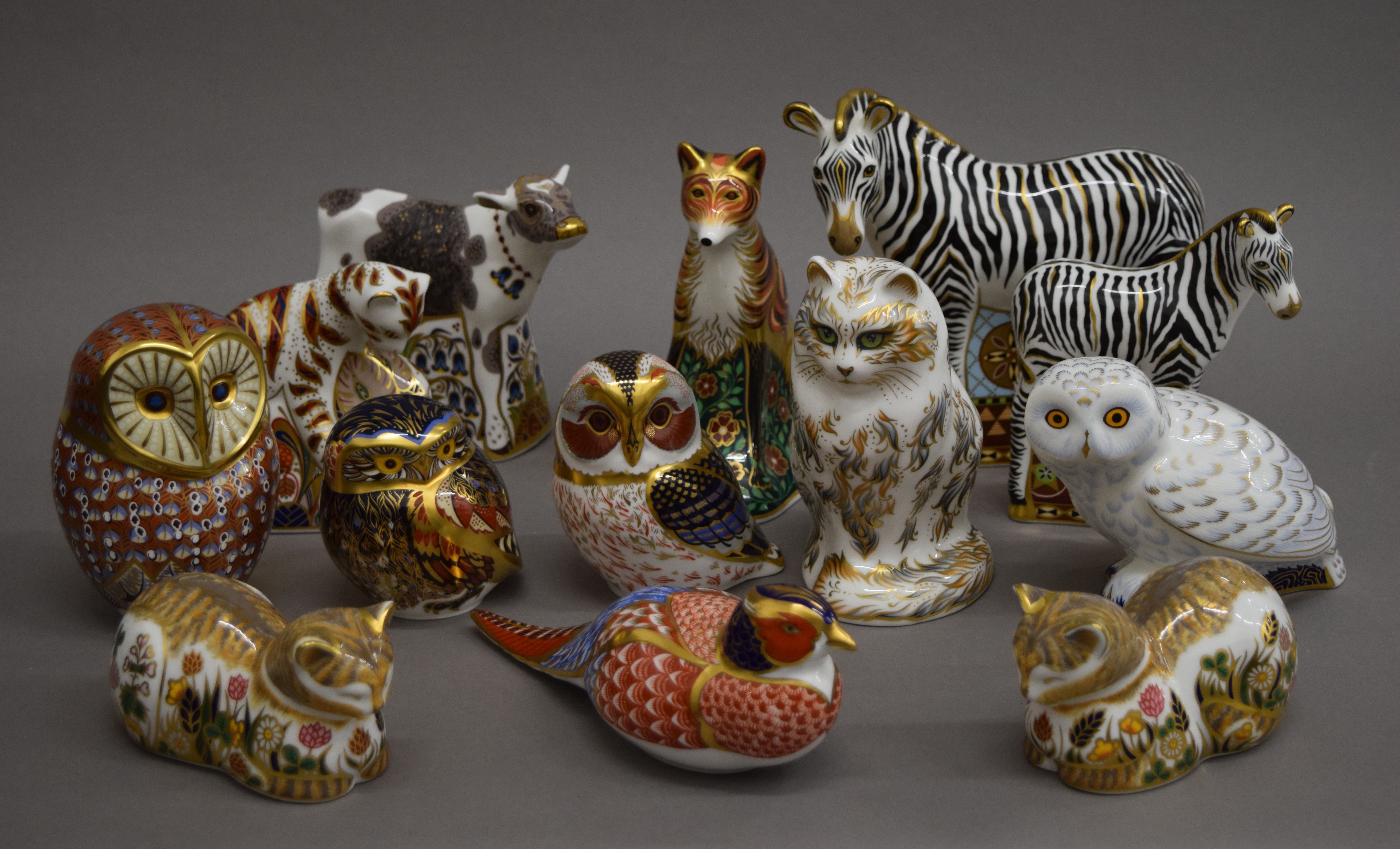 A collection of Royal Crown Derby paperweights. The largest 16 cm high.