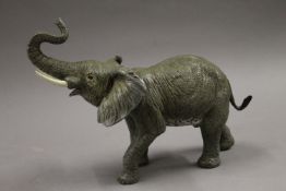 A cold painted bronze model of an elephant. 32 cm long.