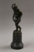 A bronze model of a boy holding a bag of letters. 28 cm high.