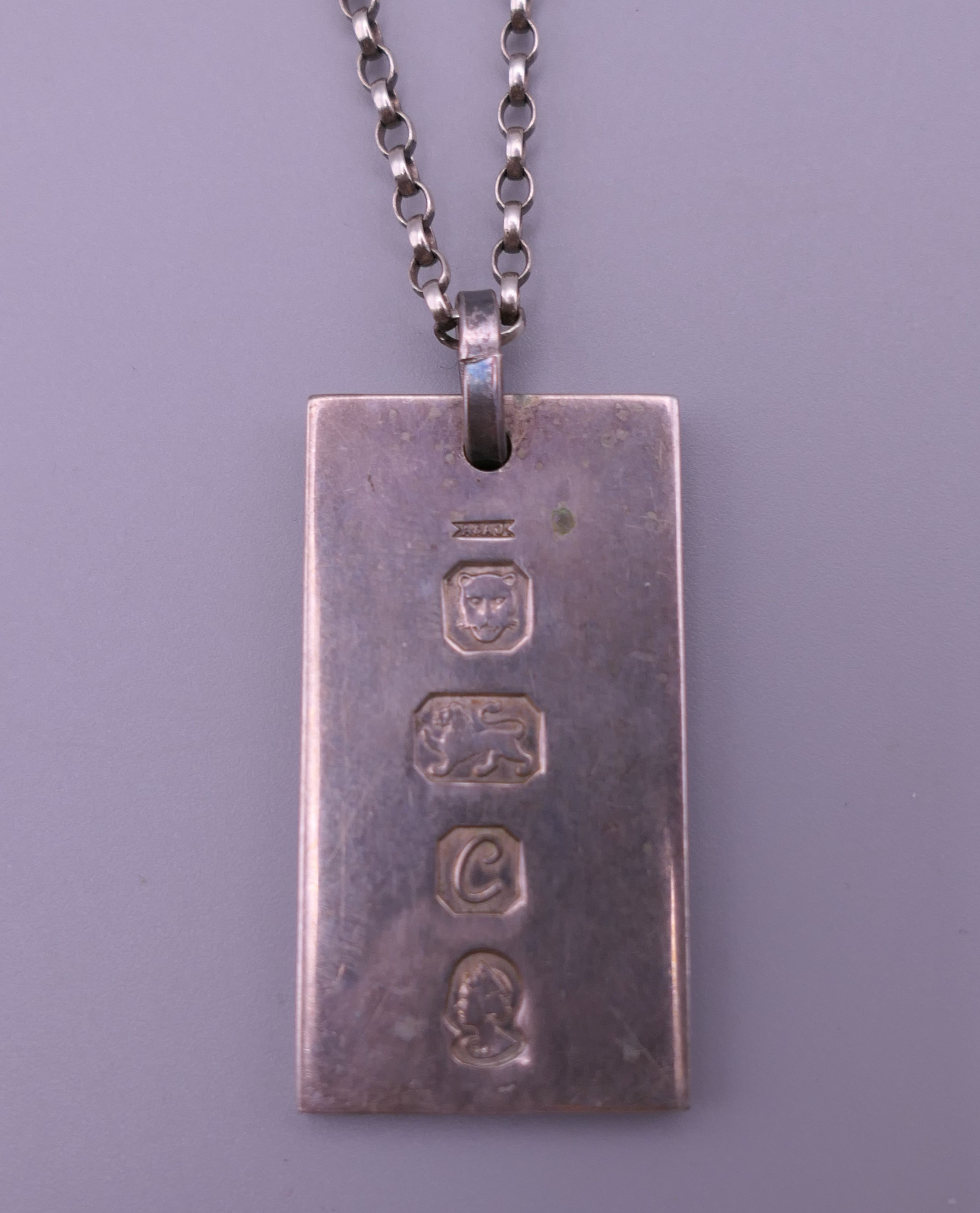 A silver ingot pendant on a silver chain. 22.2 grammes.