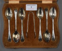 A cased set of silver teaspoons and tongs, and a cased set of silver handled knives. The former 87.