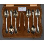 A cased set of silver teaspoons and tongs, and a cased set of silver handled knives. The former 87.