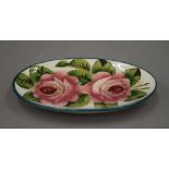 A small Wemyss oval pottery dish painted with roses. 13 cm long.