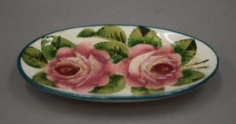 A small Wemyss oval pottery dish painted with roses. 13 cm long.