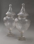 A pair of cut glass lidded urns. Each 54 cm high.