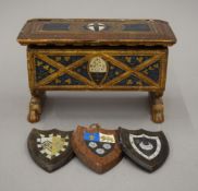 A decorative French miniature casket and three small decorative shields. The former 17.5 cm wide.