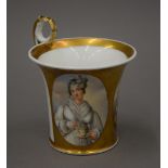 A Paris porcelain cup decorated with two figural vignettes. 12 cm high.