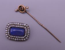 A Georgian/early Victorian yellow metal (gold) brooch and a 9 ct gold stick pin. The former 2.