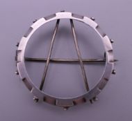 A silver keepsake circular frame brooch. 3.5 cm diameter.
