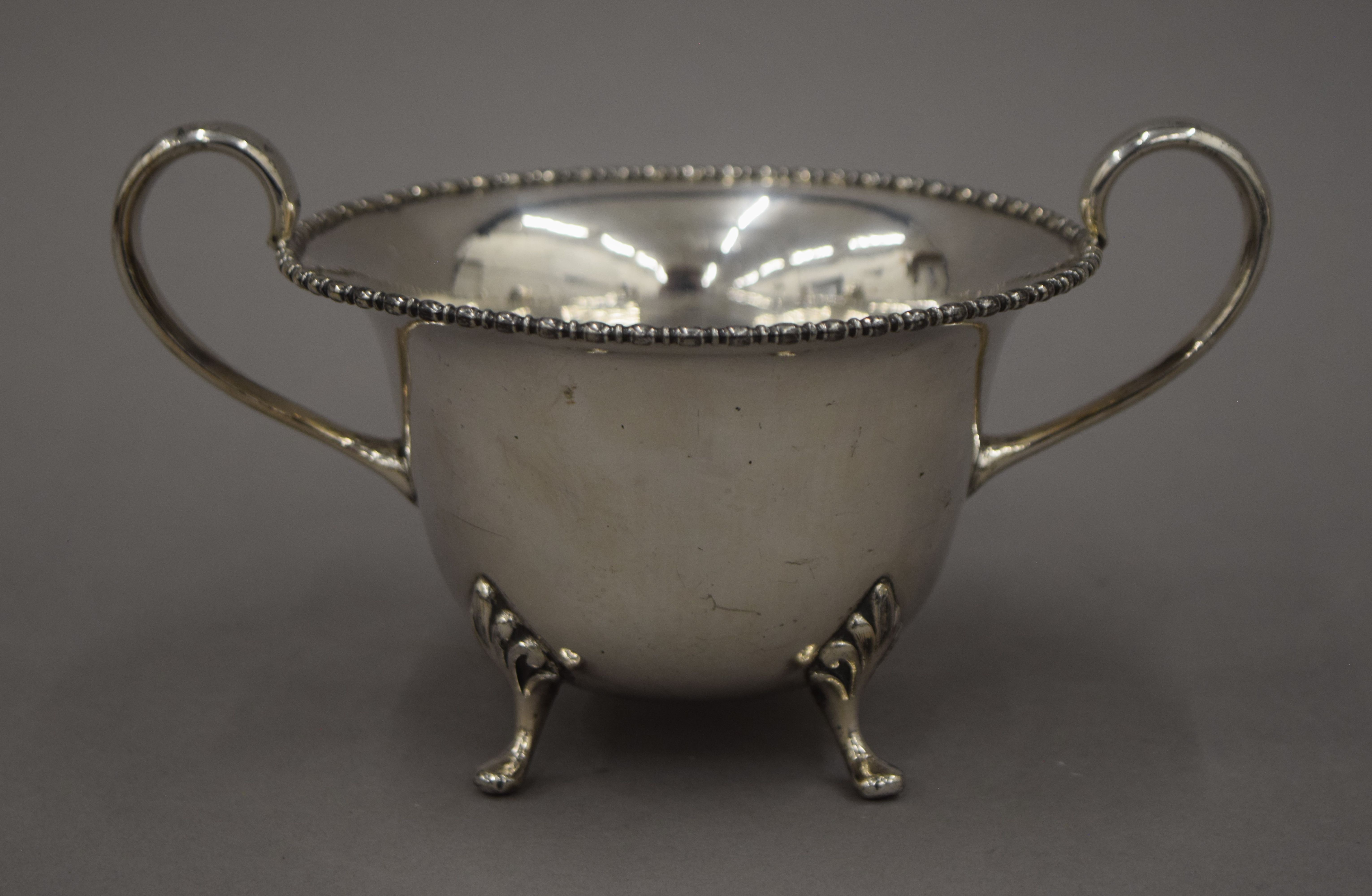 A three-piece silver plated tea set and a three-piece porcelain and silver overlaid tea set and an - Image 10 of 10