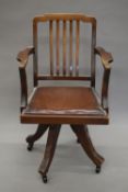 An early 20th century revolving desk chair. 57 cm wide.