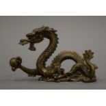 A Chinese gilt bronze dragon brush rest. 7 cm high.