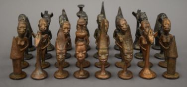 An African metal chess set and a chess board. The board 48 cm square.