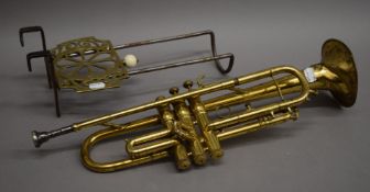 A vintage brass trumpet and a 19th century brass and steel trivet.