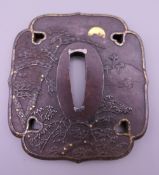 A Japanese gilt heightened tsuba. 7.5 cm high.