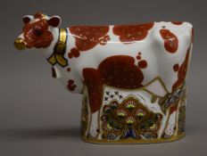 A Royal Crown Derby daisy cow paperweight. 15 cm high.