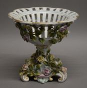 A Continental florally encrusted porcelain tazza. 19 cm high.
