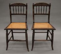 A pair of early 19th century faux rosewood cane seated chairs. 43 cm wide, 82 cm high.
