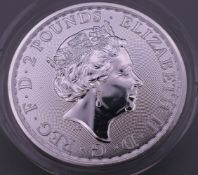 A 2020 fine silver Britannia coin in capsule.