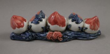 A Chinese porcelain peach form brush rest. 21 cm long.