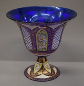 A large florally painted and gilt heightened Murano glass footed centre bowl. 34 cm high.