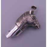 A 925 silver whistle in the form of a horse's head. 4 cm high excluding suspension loop.
