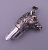 A 925 silver whistle in the form of a horse's head. 4 cm high excluding suspension loop.