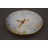 A Minton hand painted pheasant dish, signed K Scott.