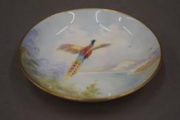 A Minton hand painted pheasant dish, signed K Scott.