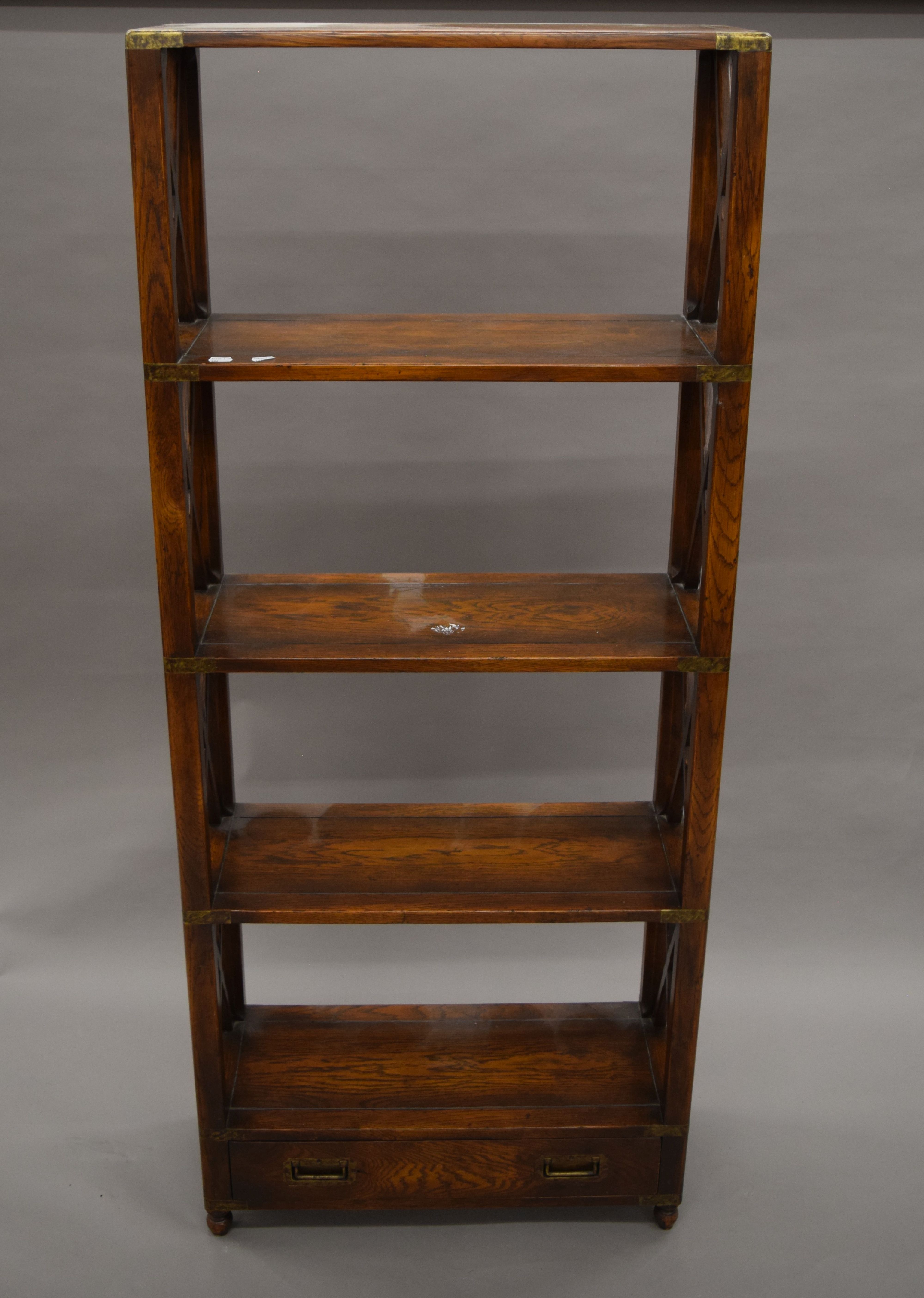 A modern brass mounted bookcase. 66 cm wide, 159 cm high.