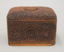An Indian profusely carved folding cigarette box. 12.5 cm wide.