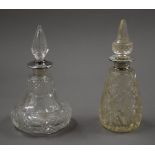 Two silver rim scent bottles with cut glass decoration. The largest 16 cm high.