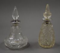 Two silver rim scent bottles with cut glass decoration. The largest 16 cm high.