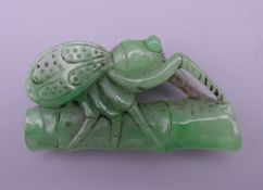 A jade model of a fly on bamboo. 6.5 cm long.