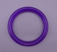 A lavender jade bangle. 6 cm interior diameter.